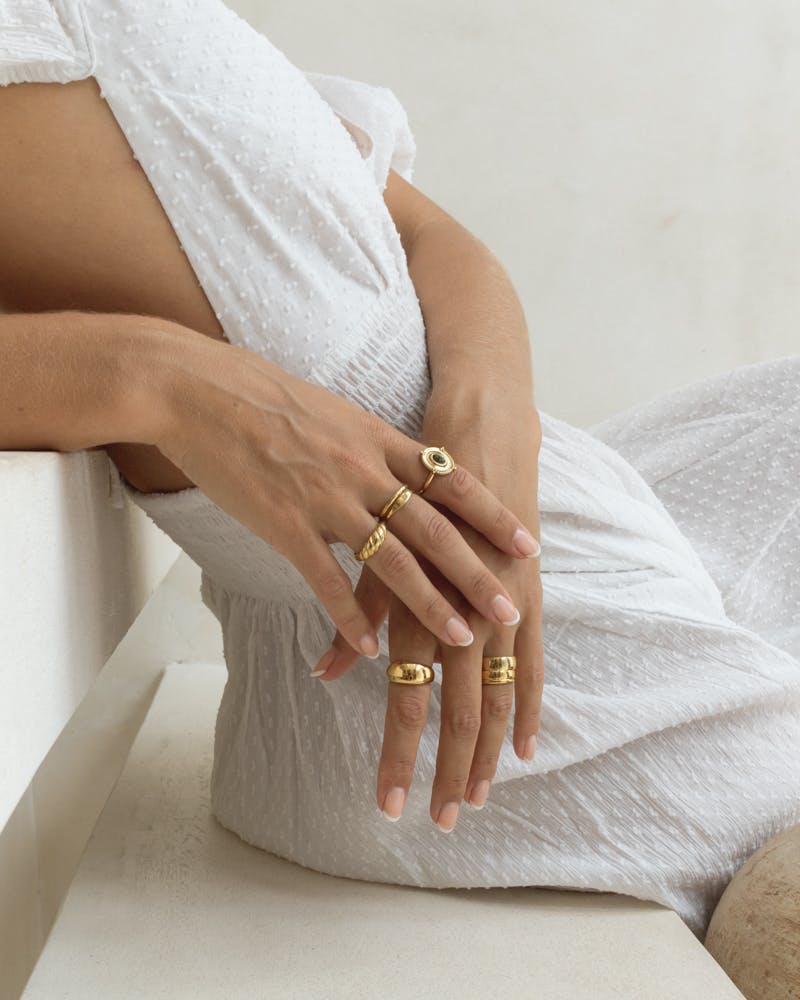 womans hands wearing sustainable jewelry